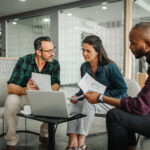 Casual meeting of diverse business team analyzing financial data